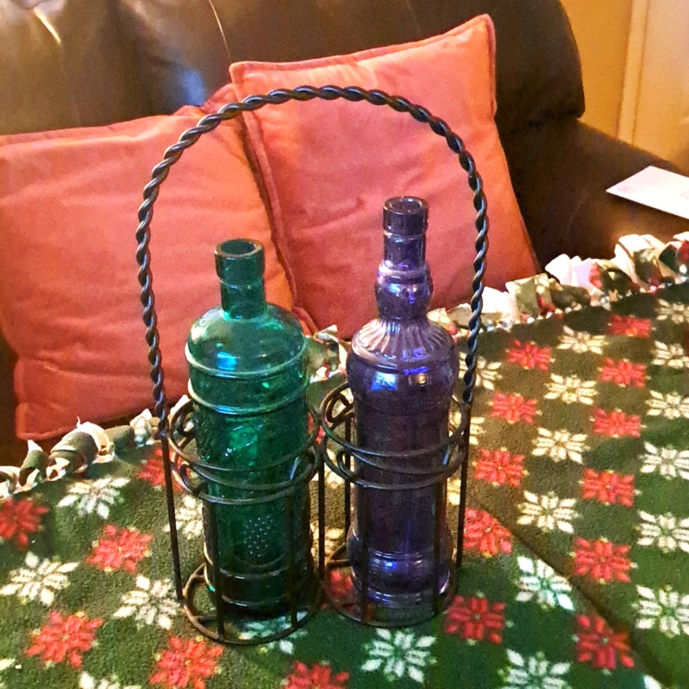 Bottle pair in wrought iron stand.